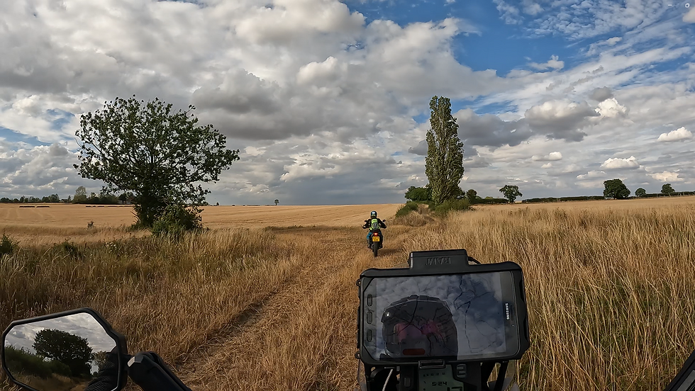 A trail bike rider checks a map in the fields
