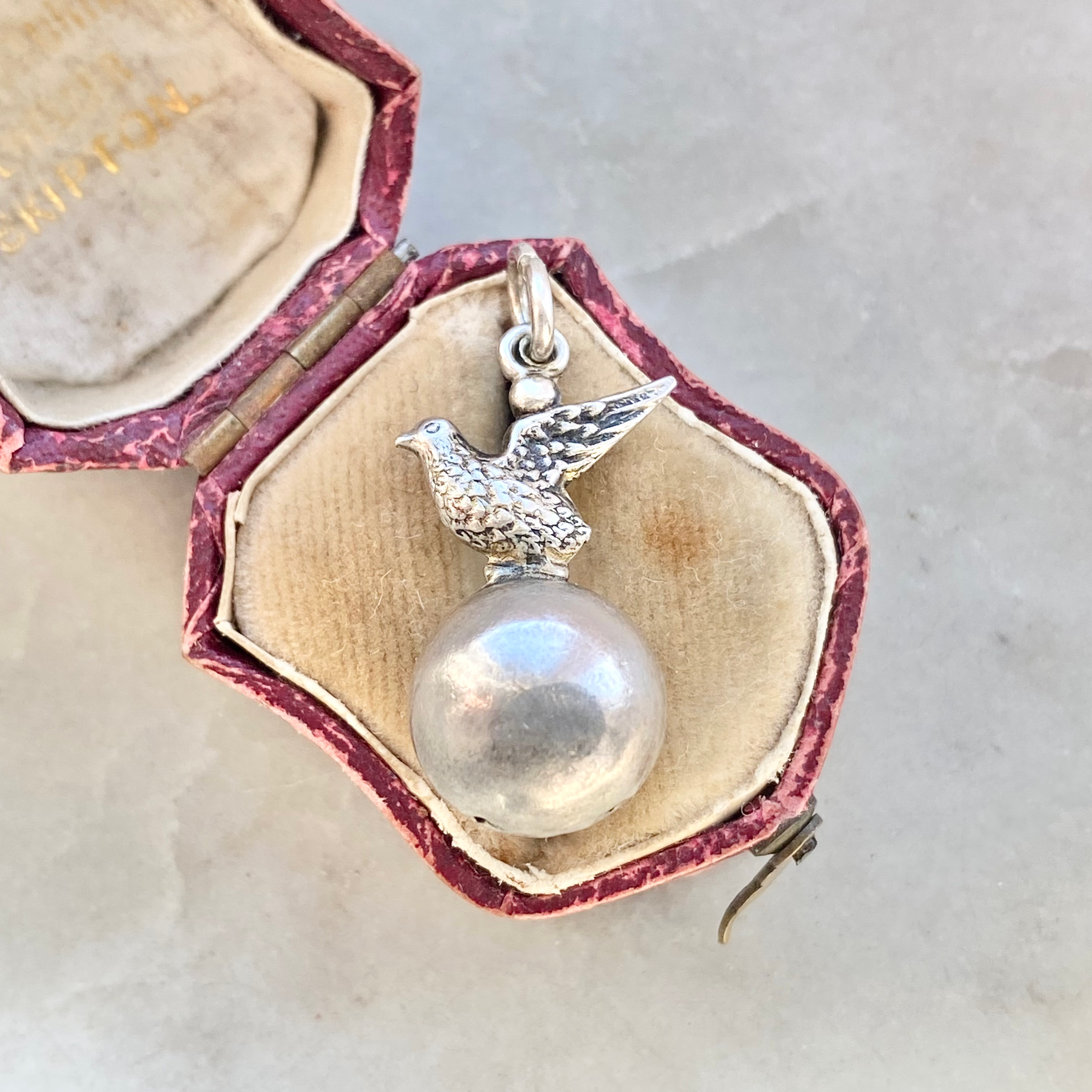 Vintage silver bird on a ball charm