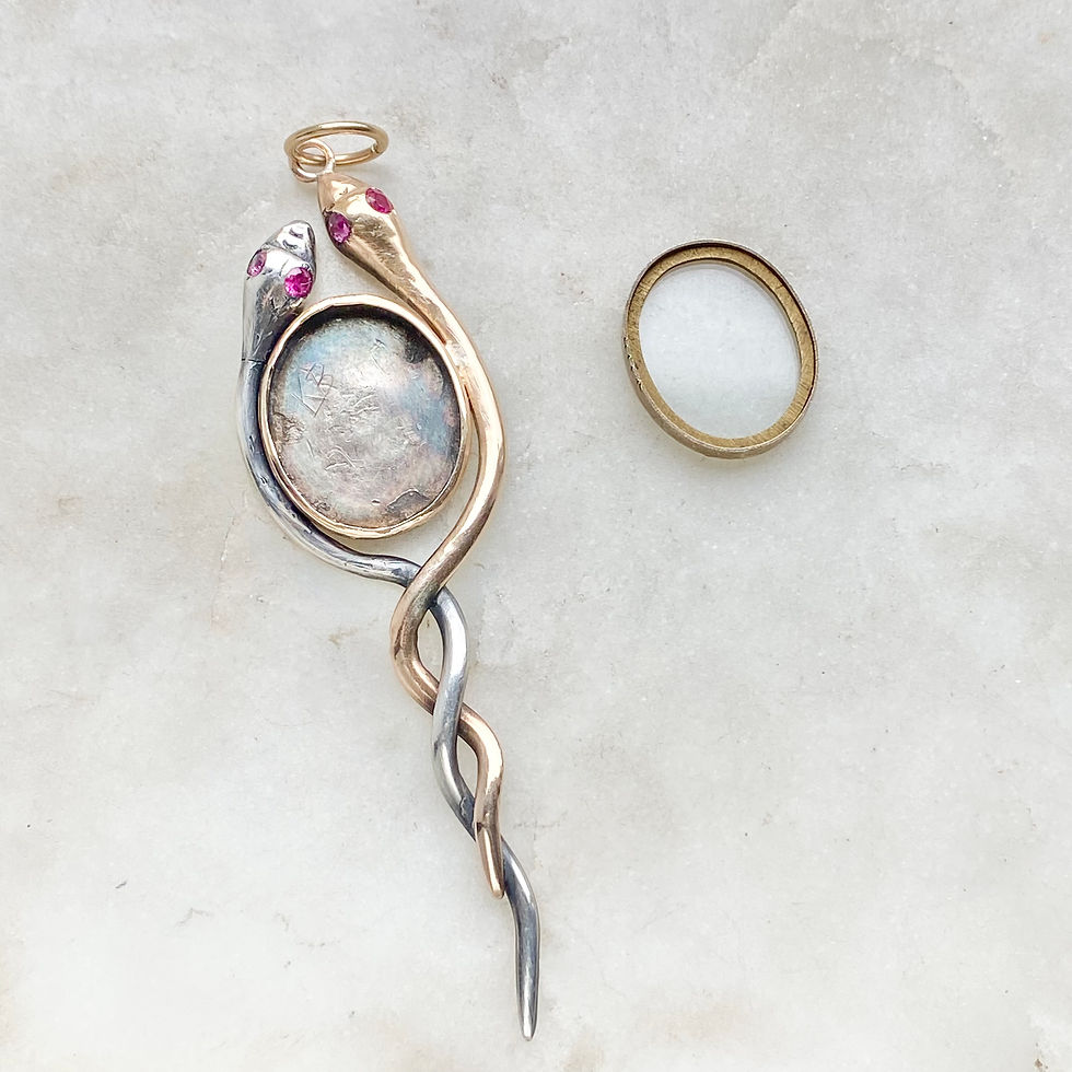 Thumbnail: Vintage intertwined gold and silver snakes locket pendant with gemset eyes