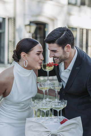 couple are drinking from the champagne tower