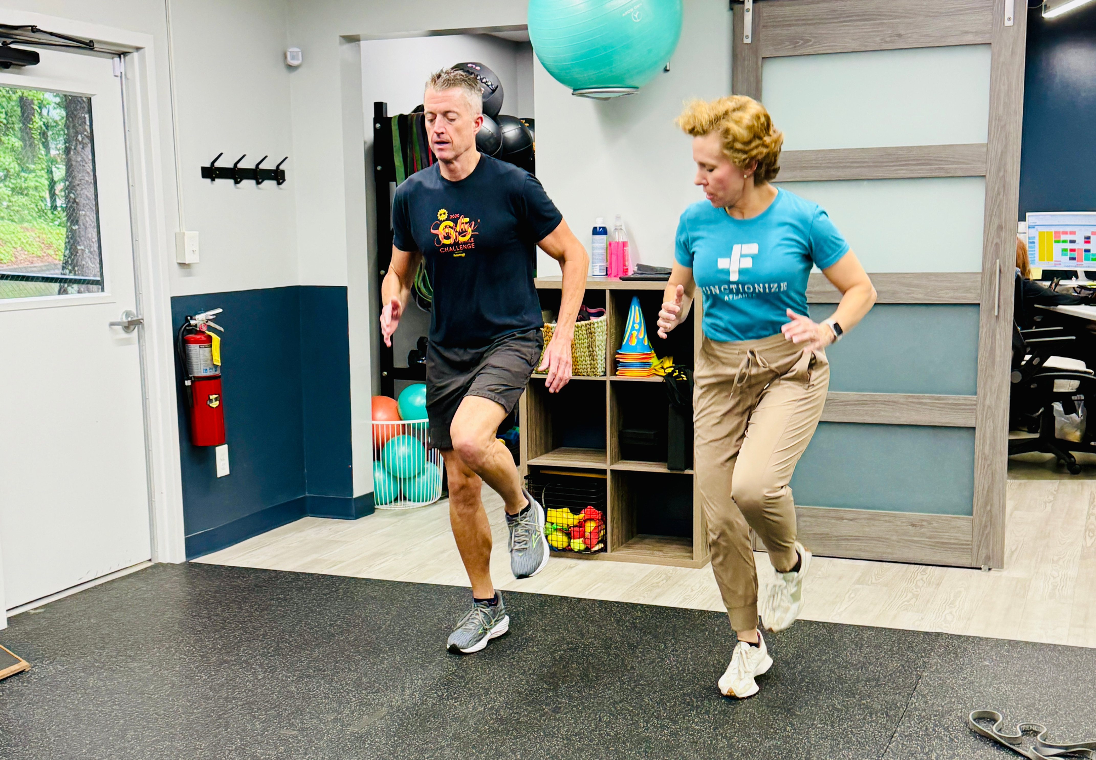 Physical therapist doing high-knee exercises with patient at Functionize Health & Physical Therapy in Dunwoody