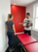 Patient working with a physical therapist at a manual therapy clinic in Astoria, NY during initial movement assessment
