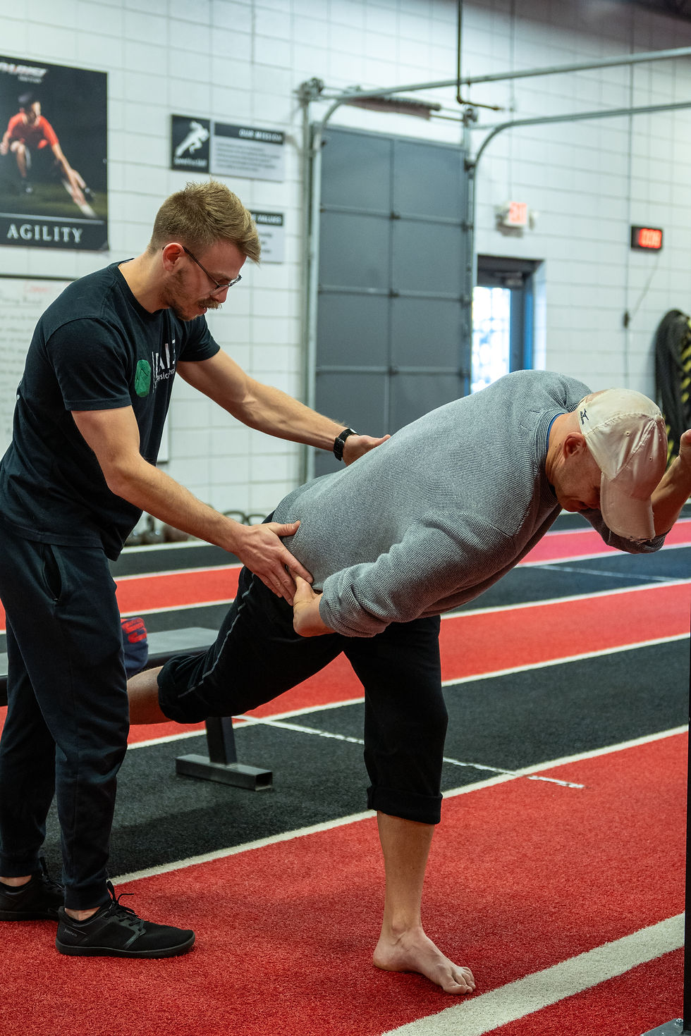 Patient working with a provider at a sports physical therapy clinic in Greenville, SC during a movement screen assessment