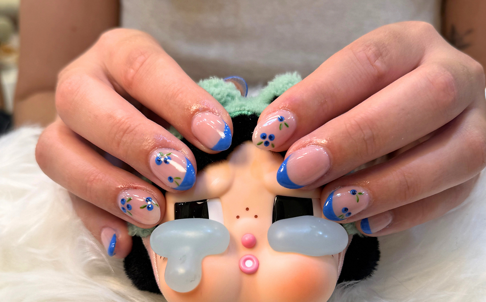 A girl showing her nails while holding a teddy bear