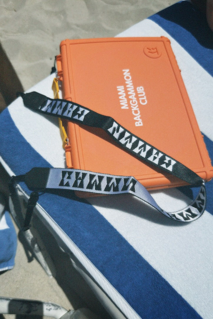 People lying on mats with eye masks, covered in blankets in a room with floral wallpaper. The atmosphere is calm and relaxing.