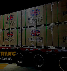 A truck loaded with UK Solar Power solar panels and street lights highlighting our experience working with sub-distributors across 23 global locations.