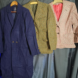 Set of 3 mens tweed jackets hanging side by side.