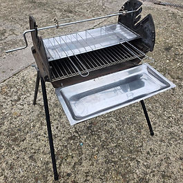 An Allibert Weekender Cast Iron Charcoal Barbecue in a garden.
