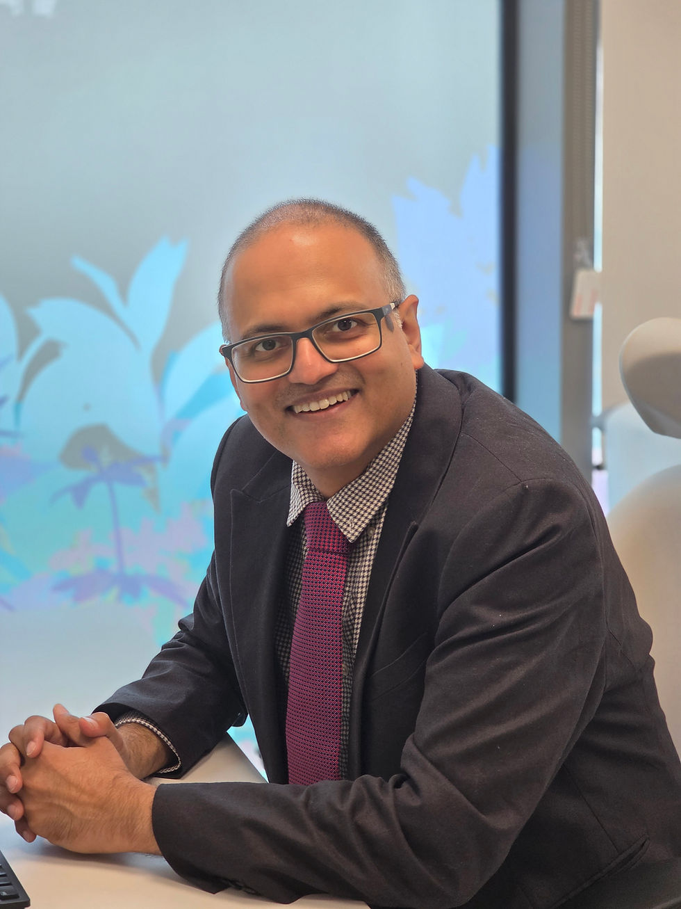 Dr Kishore at his desk at The Harborne Hospital, Edgbaston