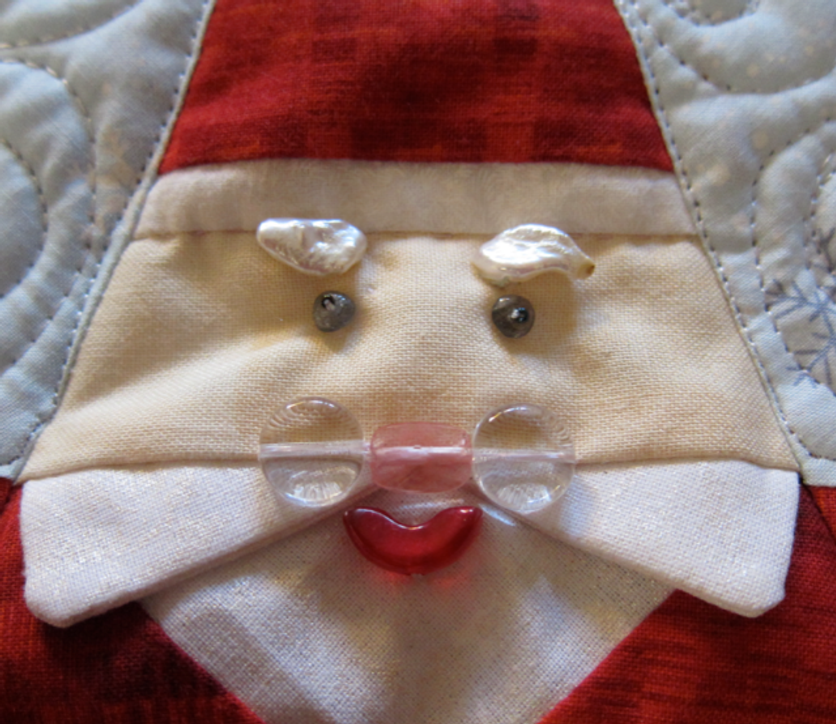 Detail from Santa Smiles Tree Skirt--face details are German glass beads and seed pearls.