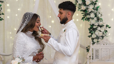 Groom feeding bride cake after Nikkah ceremony at Oxford Beckley Village Hall.