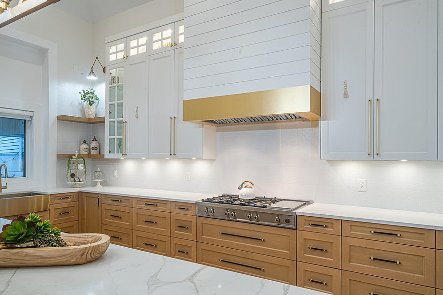 CUSTOM KITCHEN WITH GOLD RANGE HOOD AND NATURAL WOOD CABINETRY.jpeg