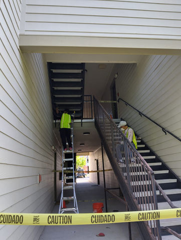 craftmen preparing a building stair to be painted