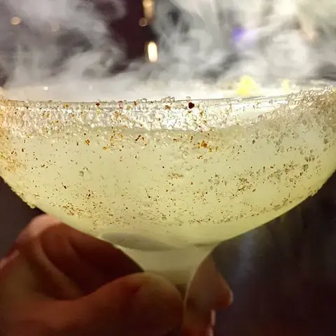 Smoky cocktail at The Woolworth Dallas, TX – a dramatic presentation of a smoked Old Fashioned, highlighting the bar's unique approach to mixology.