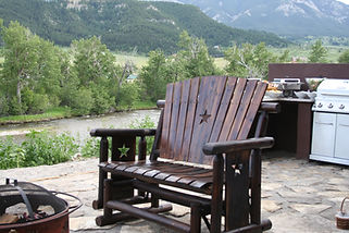 Outdoor granite kitchen and stone patio overlooking Stillwater River and Beartooth Mountains