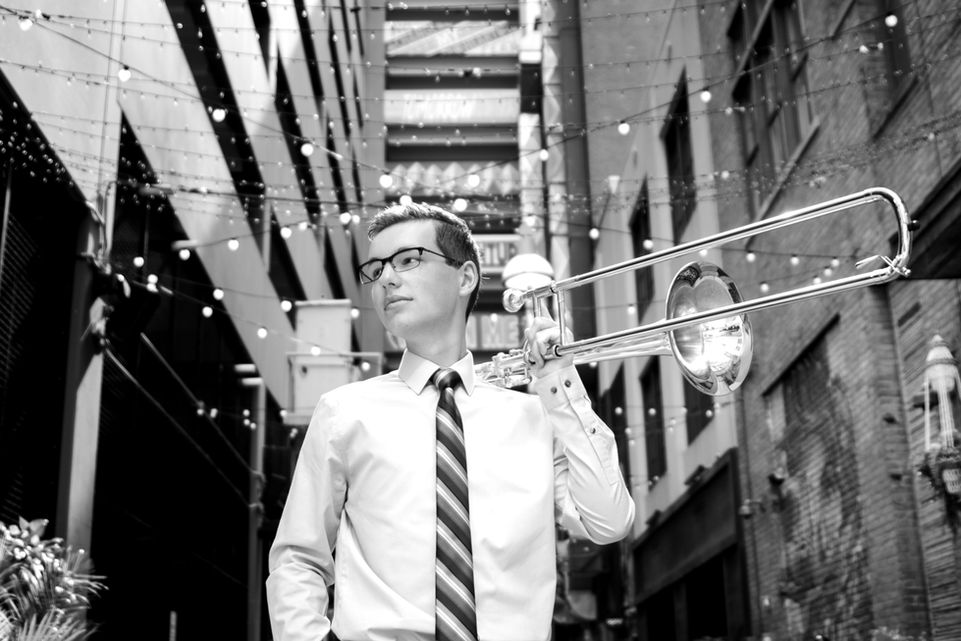 Senior Pictures Michigan. Senior boy downtown in alley with trombone