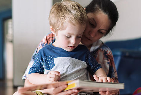 Woman reading book to child