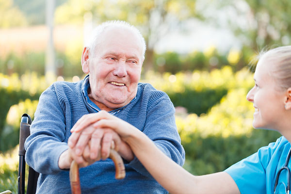 Aged care worker with elderly gentleman in wheelchair