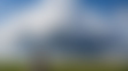 Woman in an Illinois cornfield gazing at a giant cumulus cloud, illustrating why clouds don’t fall even though they can weigh hundreds of thousands of pounds.