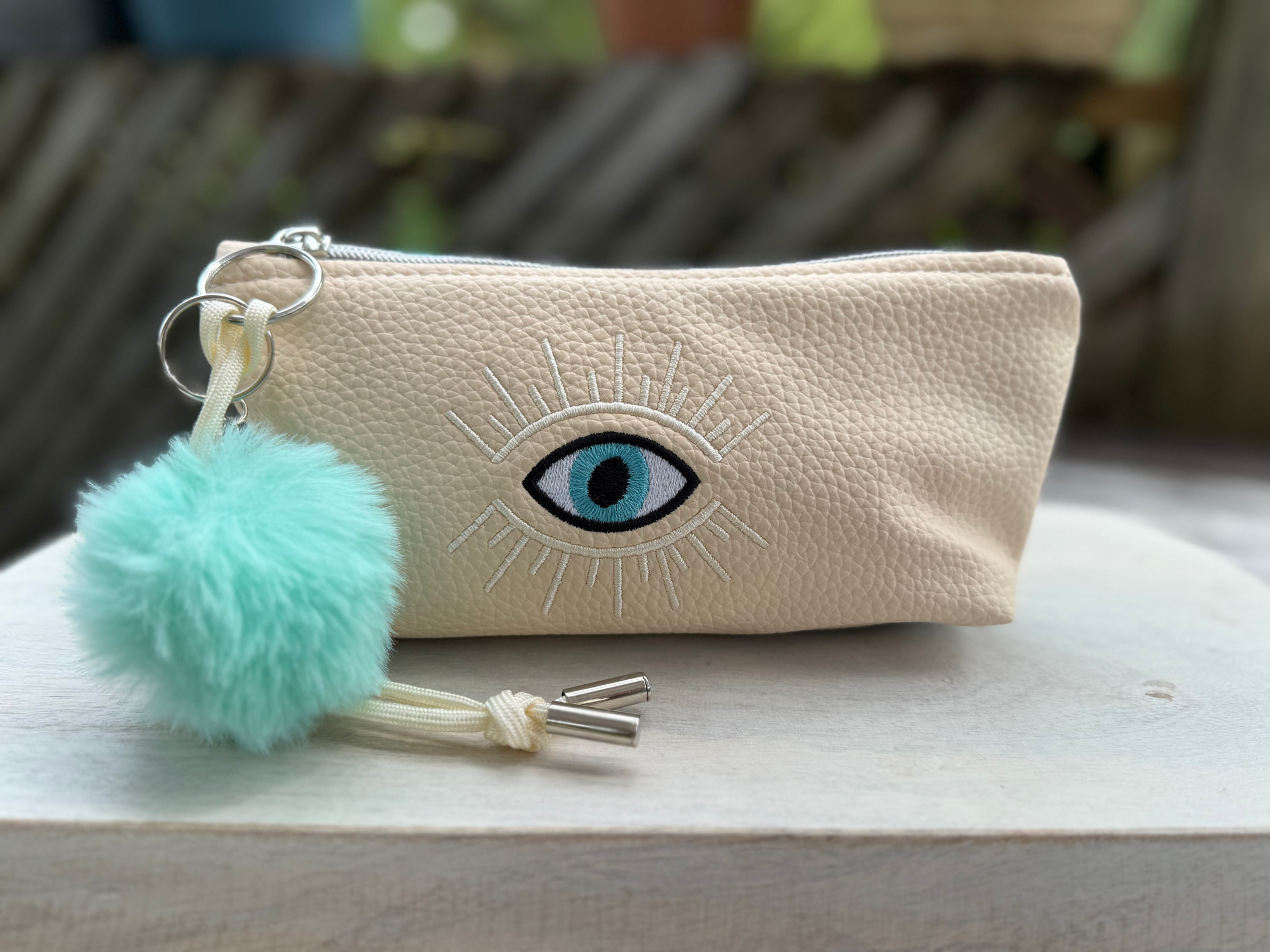 Sol Teal & Tan  "Evil eye"  vegan leather clutch with Pom Pom