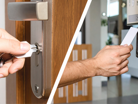 Hands unlocking doors: one with a metal key, the other with a keycard on a keypad lock. Modern interior, wooden doors, secure access.