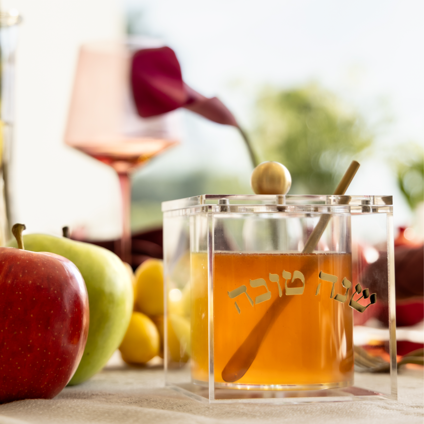 Clear Crescent Honey Jar with raised gold Hebrew Shana Tova lettering and metal spoon