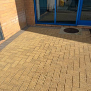 Clean, restored commercial sandstone block paving outside a Stafford business premises after professional jet washing.