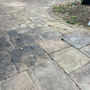 Close up of stubborn black spots and algae staining on patio indian stone
