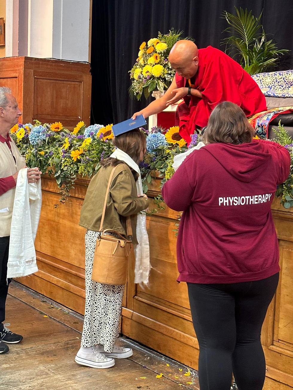 A photo of myself receiving white tara empowerment with the honourable Yongey Mingyur Rinpoche.