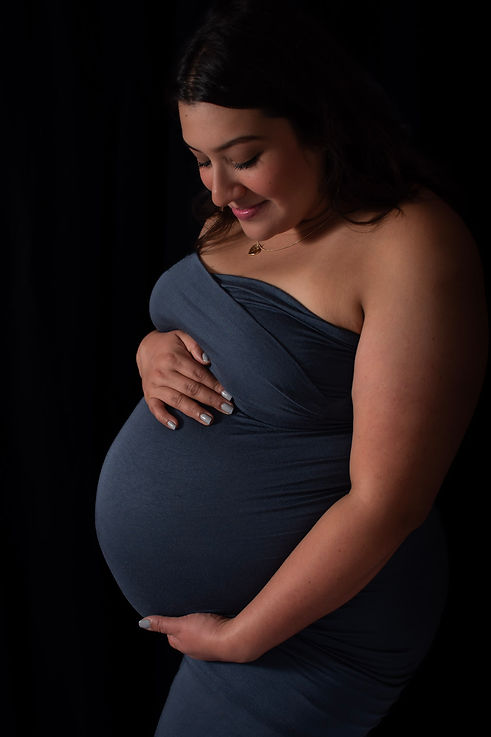 In studio maternity portrait with pregnant belly showing.jpg
