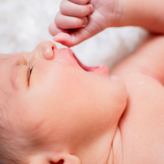 Picture of baby yawning during at home newborn session in Houston