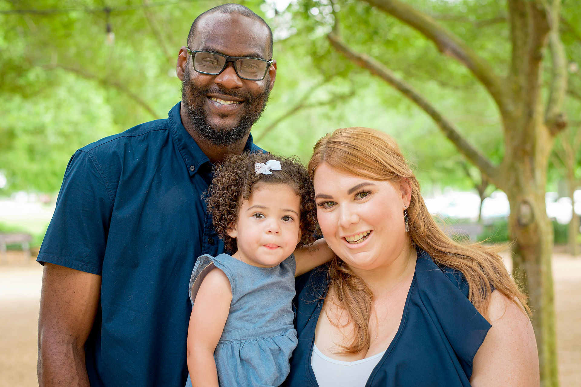 family portrait with lake in background at Sugar Land Memorial Park 