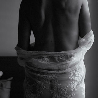 Bridal boudoir photos with white lace robe showing back in natural light