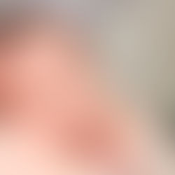 photo of newborn baby resting on moms shoulder with natural light and tiny baby fuss hair showing little details and big eyes