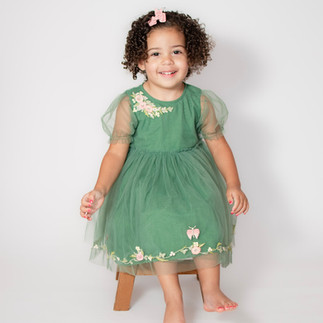 Picture of toddler girl sitting and smiling at the camera