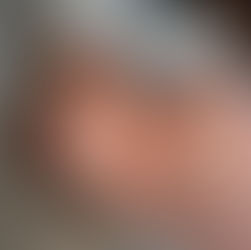 newborn baby looking up at mom with big eyes and natural light