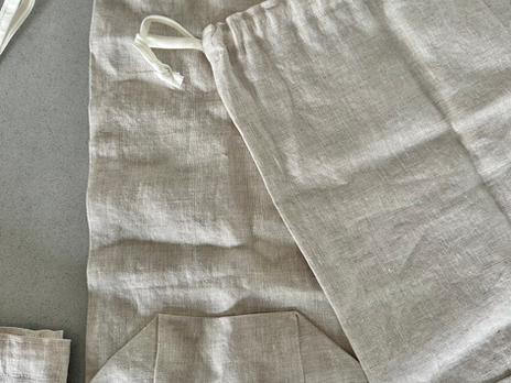 a beige bread bag lays on a grey counter top