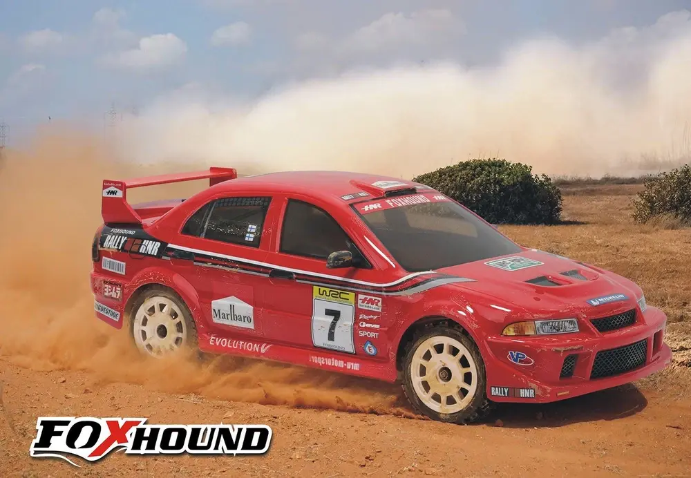 Red rally car racing with number 7 on dusty track with