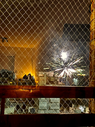 A firework exploding through netting