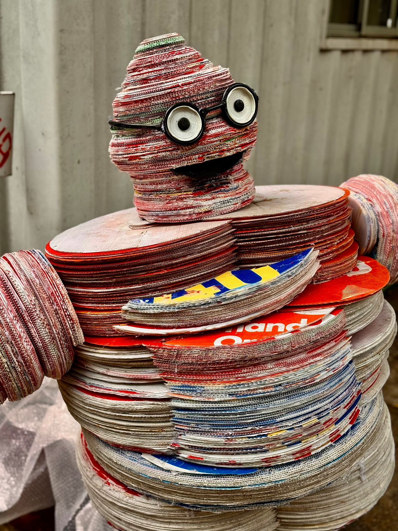 Scuplture of a figure made out of election posters