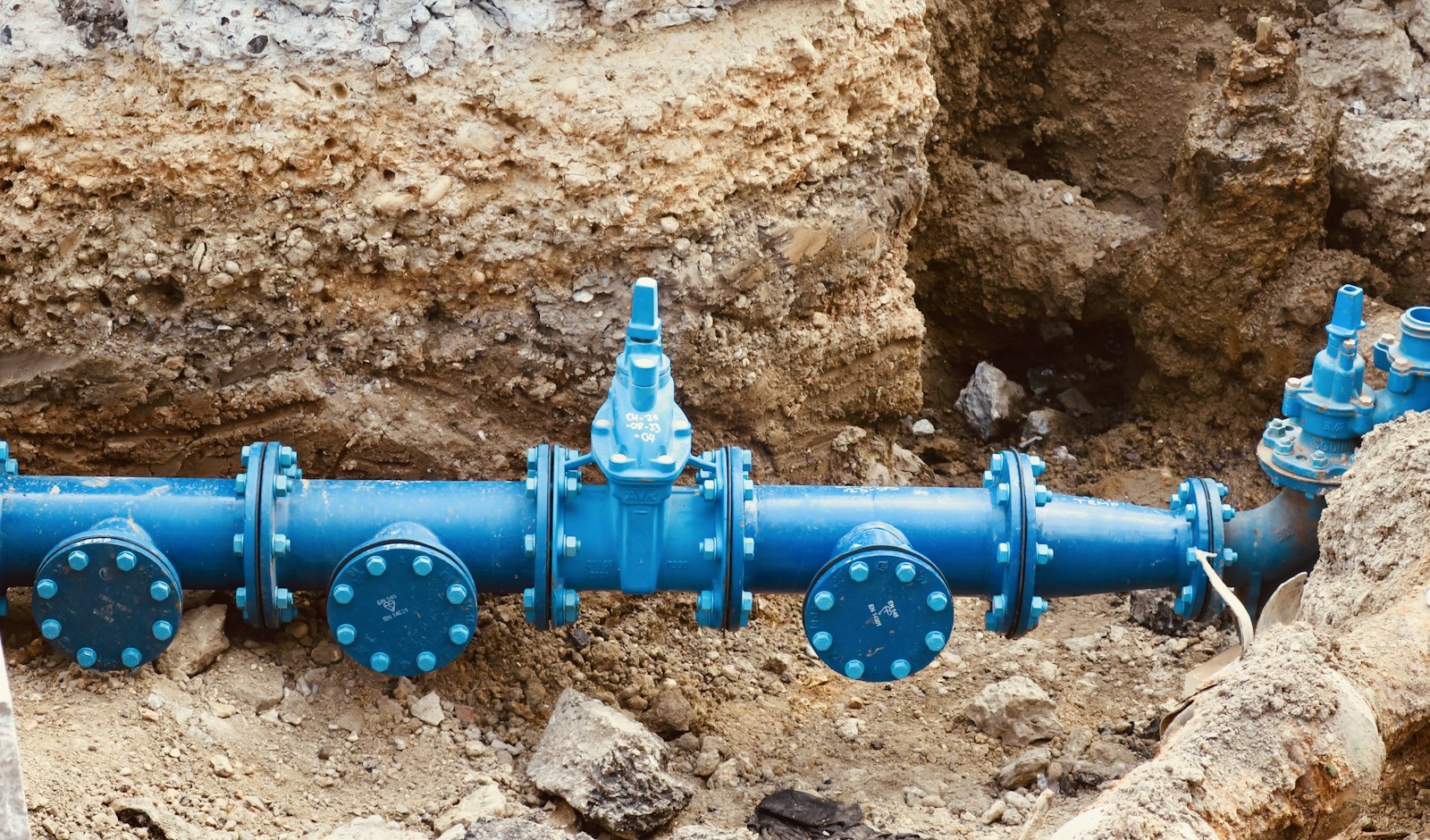 Utility pipe laid beside an open excavation