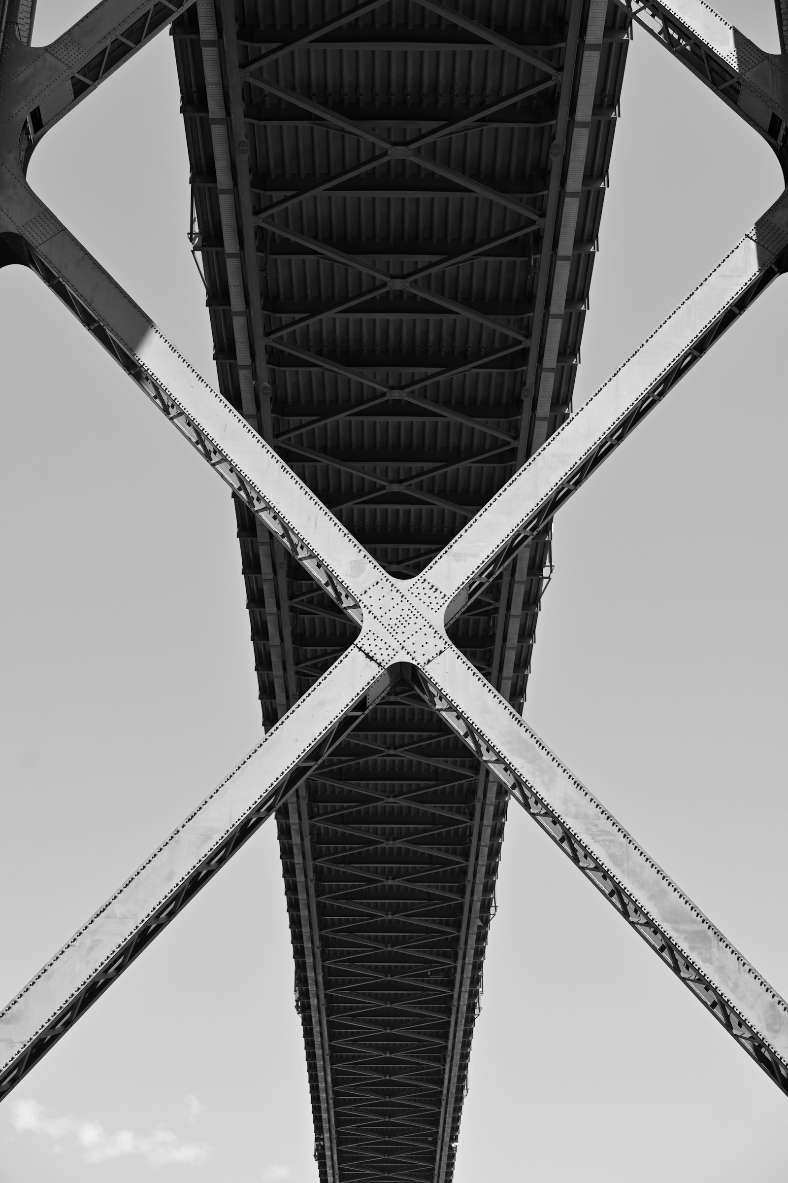 Underside of a riveted steel truss bridge
