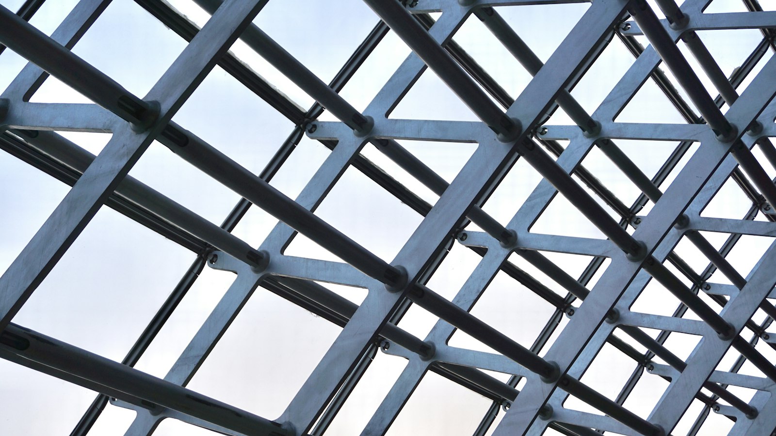 Steel frame and glass roof structure seen from below