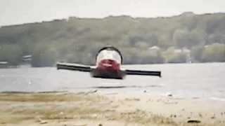 The Hammacher Schlemmer Hovercraft flying or hovering low over water and then land.