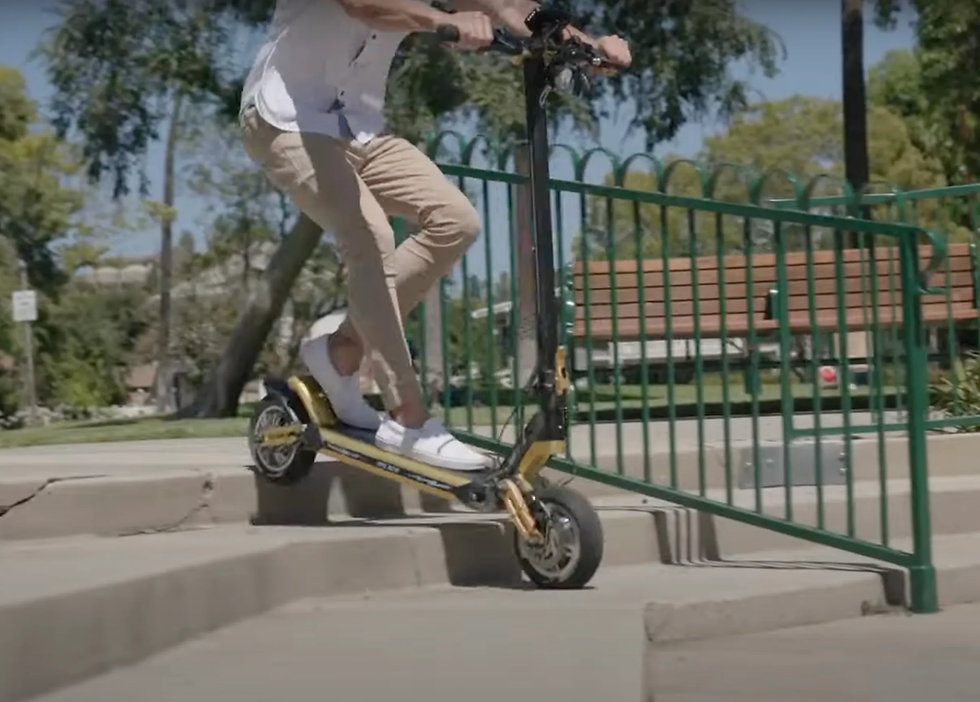 A closer look at a Thunder electric scooter rider traversing a set of stairs.