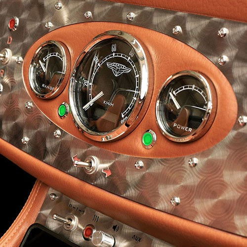 A closer look at the analog speedometer and power panel of the TC2 sports car.