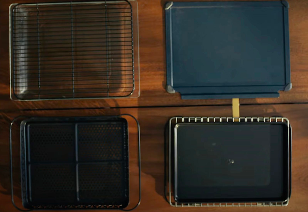 A view of the included pans and trays used for cooking.