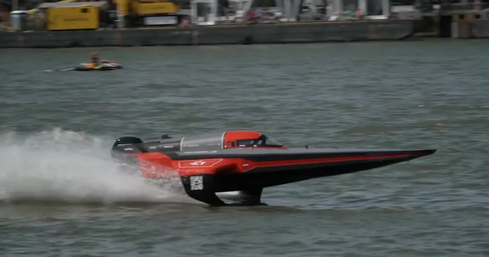 A red Rcebird E1 Series powerboat flying along the water