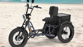 A parked Tour E-Trike on a sandy beach