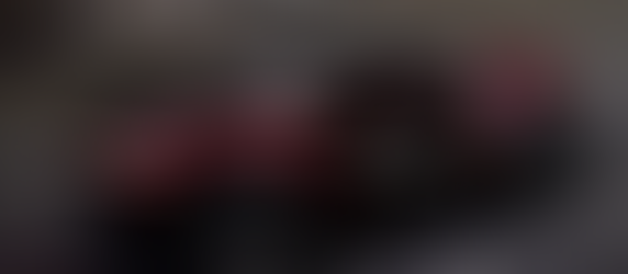 An angled view of a cruising Callum Skye electric SUV in an urban setting